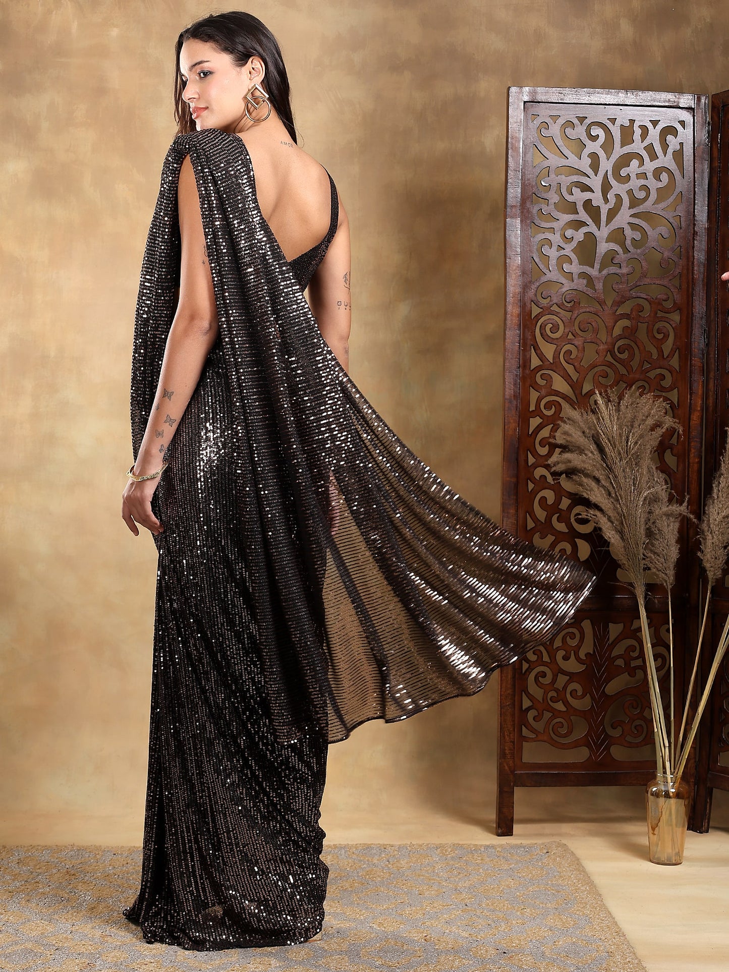 Black base with gold sequin stitched saree